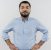 young-bearded-man-blue-shirt-looking-front-with-arms-hip-smiling-confident-standing-white-wall.jpg